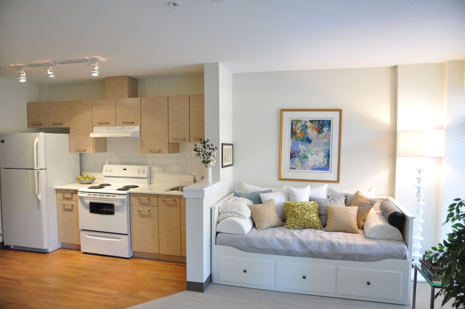 Open studio layout with kitchen and daybed