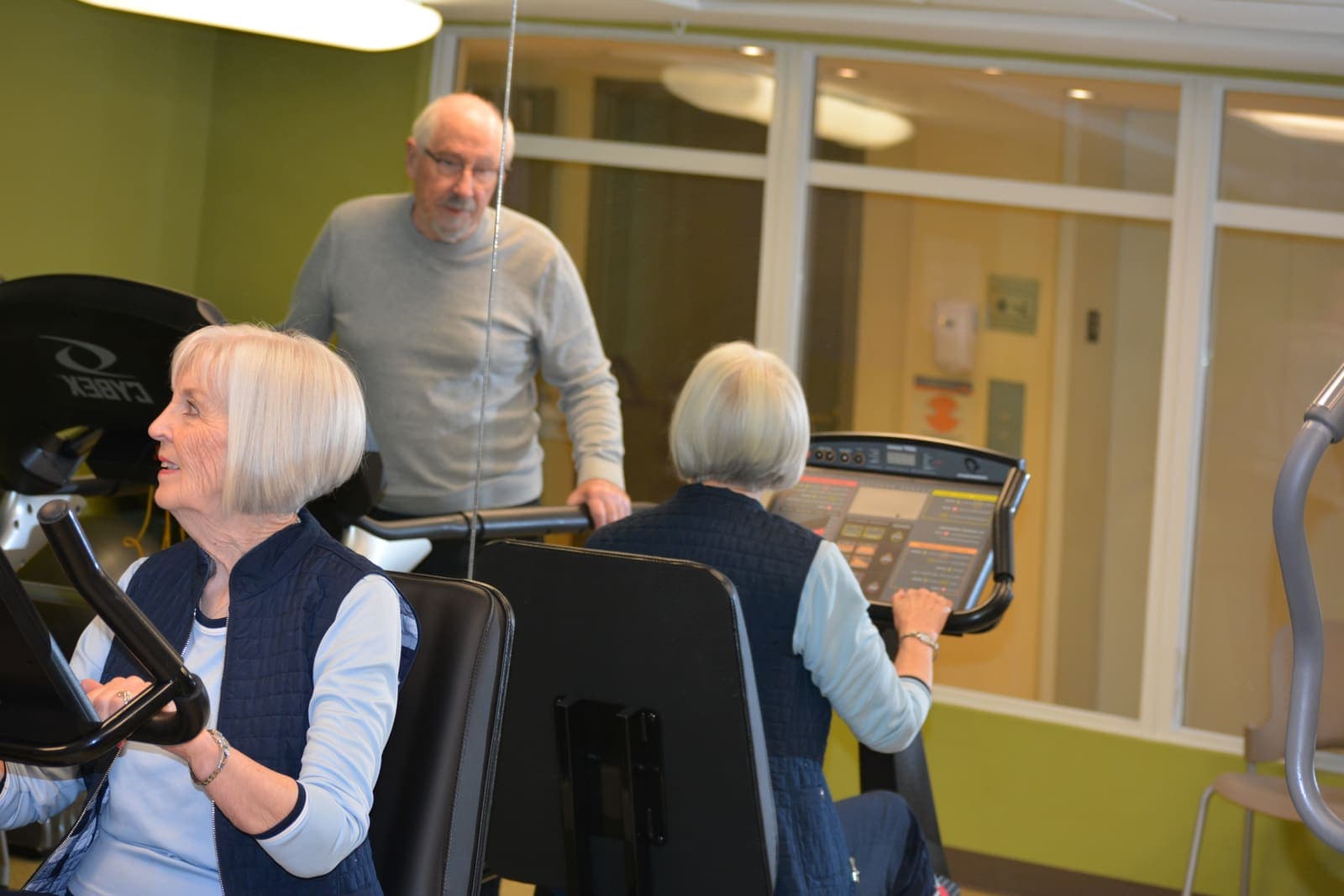 Staff coaching residents in the fitness room